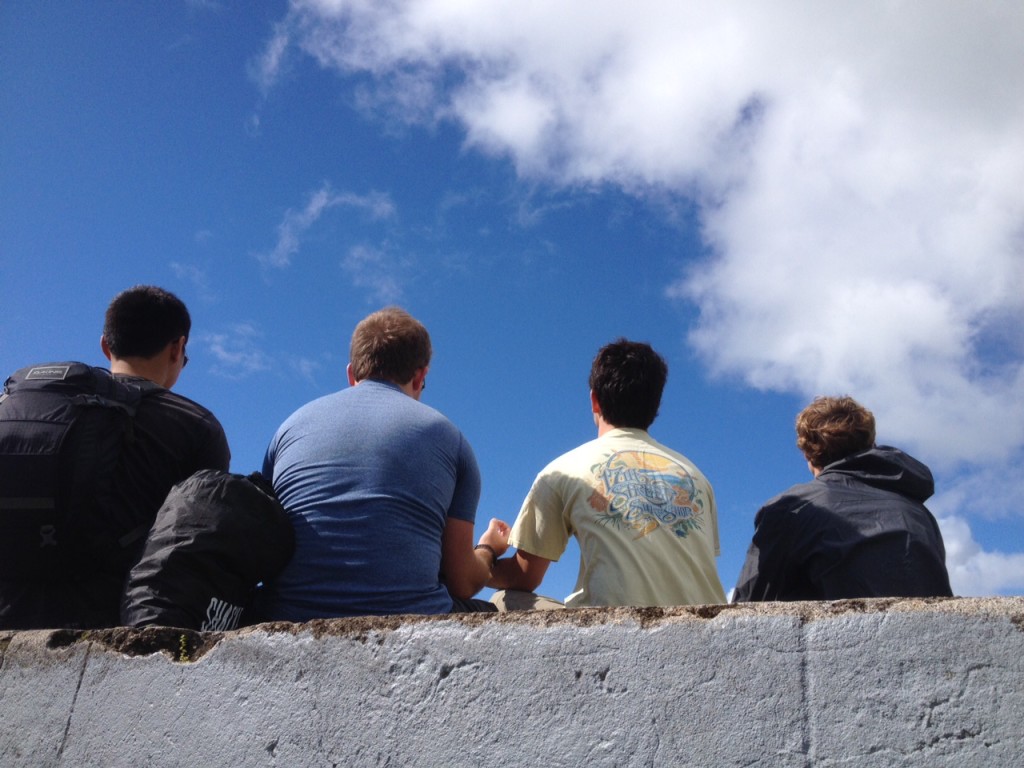 The boys ponder the meaning of the long white cloud.